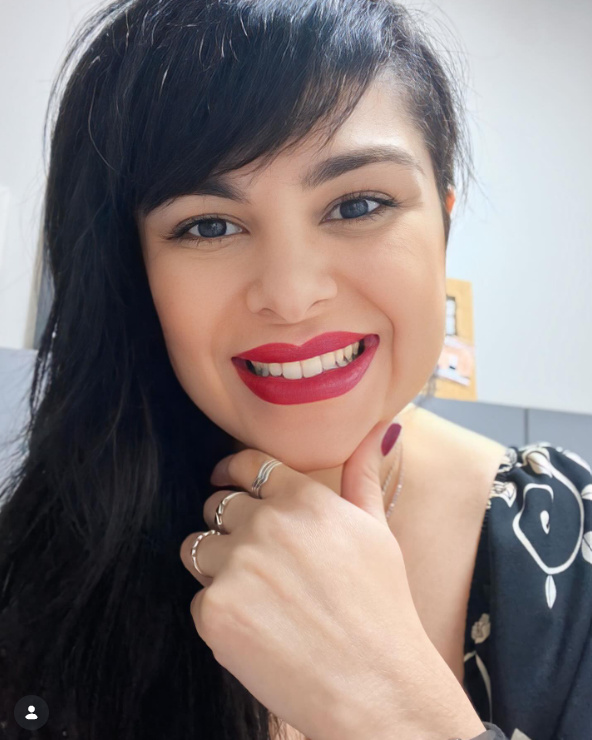 Postagem do Instagram: selfie de Tariane sorrindo, com batom vermelho e a mão apoiada no queixo